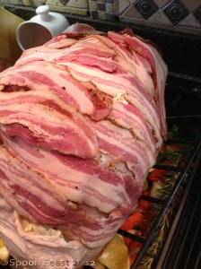 Cover with bacon strips to baste the turkey during the initial phase of roasting. Remember the large bird will roast for several hours. After the first 2-3 hours, the bacon will be done, remove it and this becomes the "cooks treat". Continue roasting the bird, basting every 30-40 minutes. The skin will crisp and become golden brown. If the skin starts to get too brown before the bird is done, tent it with foil.