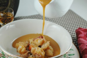 Mound a bit of the cooked seafood in the bottom of the serving bowl; pour the hot soup over the shrimp and lobster.