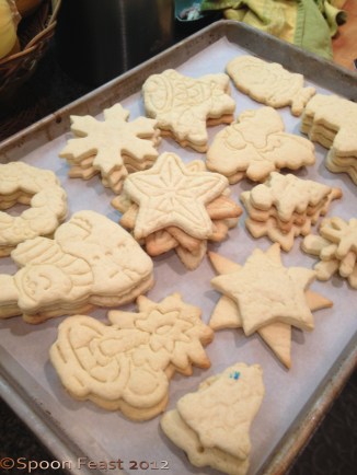 Lay the baked cookies on a baking sheet, organized by shape. It will make it easier to decorate them faster.