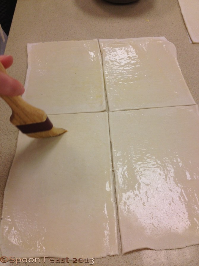 Cut the puff pastry to fit the apples; egg wash.