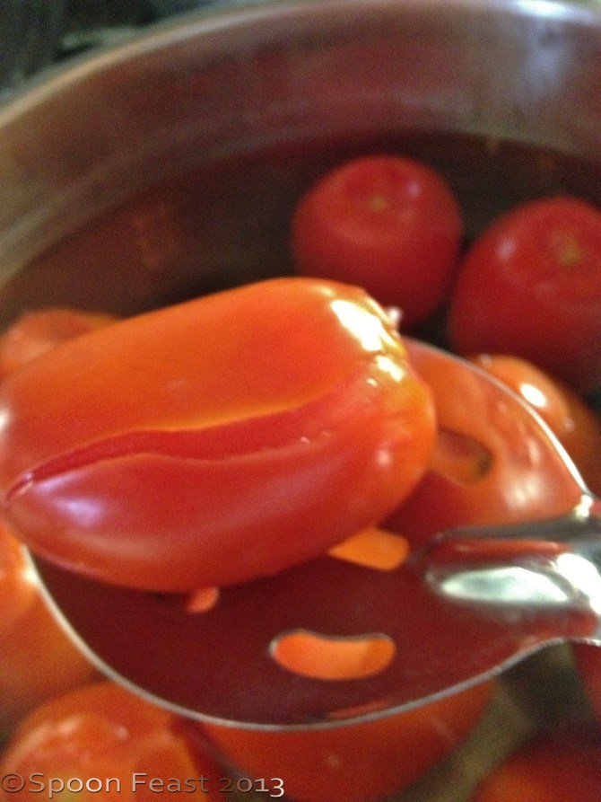 The skin will split when ready, the more ripe the tomato, the quicker this happens.