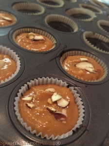 Add the peanut butter layer, top with toasted nuts before freezing